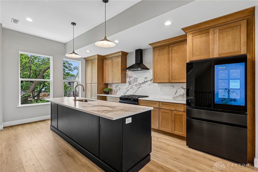 3906 Edwards Road, Unit C Cincinnati, OH 45209 - Photo 10 of 46 This sleek kitchen features a spacious island and top-of-the-line appliances for modern living.