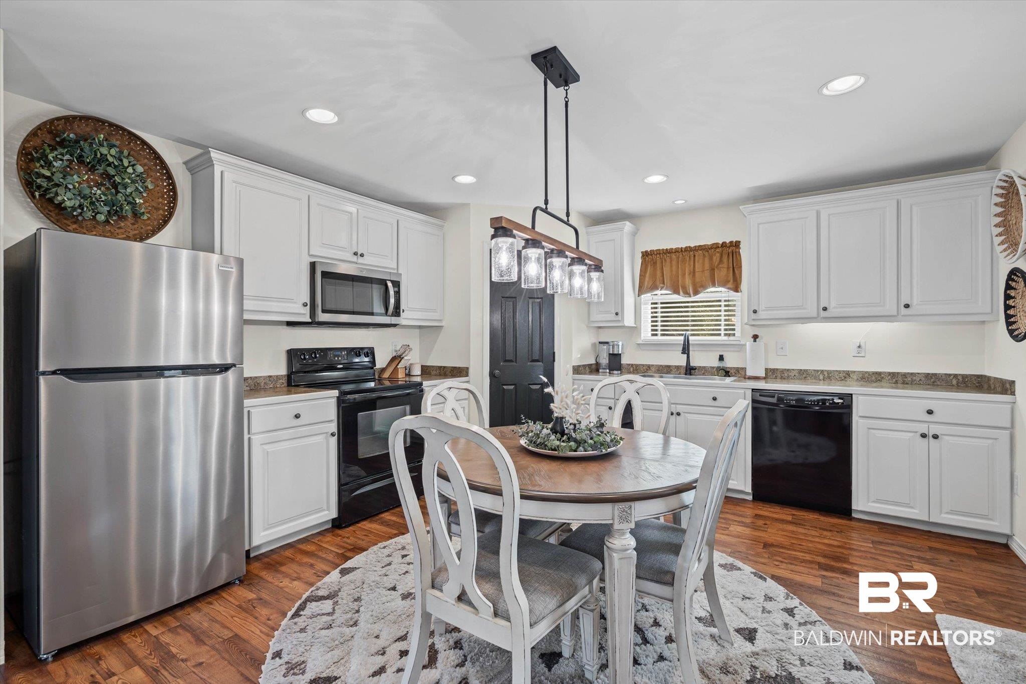 4567 Pine Avenue Saraland, AL 36571 - Photo 26 of 48 Kitchen featuring black appliances, white cabinetry, recessed lighting, decorative light fixtures, and dark wood finished floors
