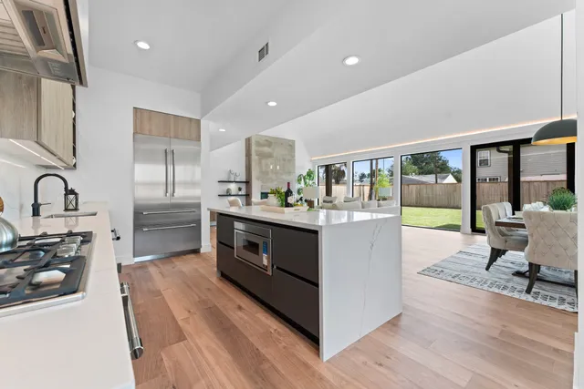 a kitchen with stainless steel appliances granite countertop a stove and a sink