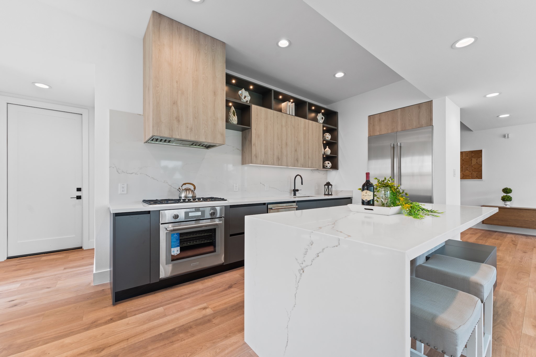 6711 Housman Houston, TX 77055 - Photo 16 of 49 a kitchen with stainless steel appliances kitchen island granite countertop a stove a sink and a refrigerator