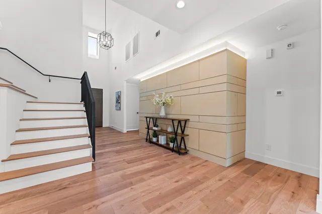 a view of entryway and hall with wooden floor