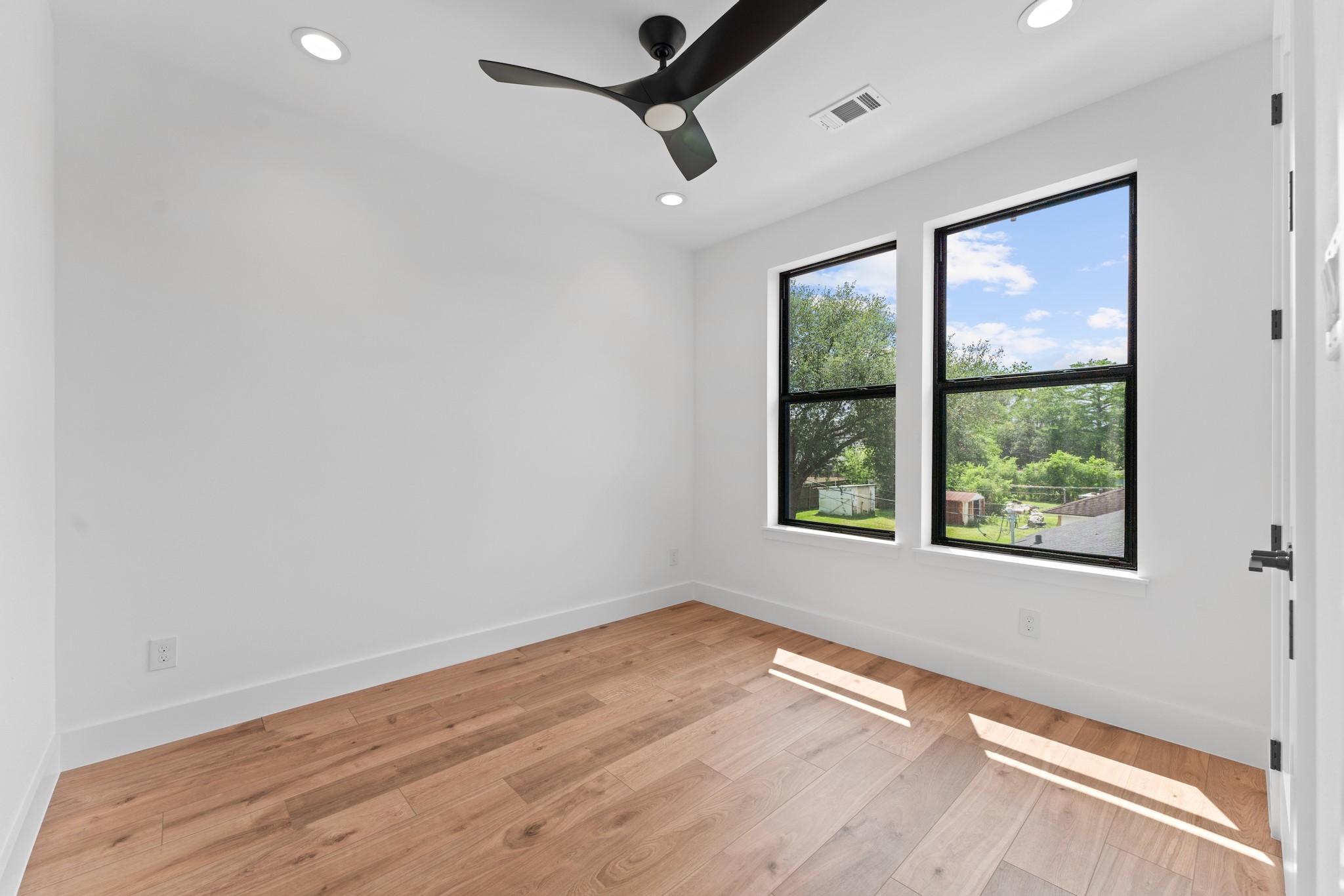 6711 Housman Houston, TX 77055 - Photo 44 of 49 a view of an empty room with wooden floor and a window