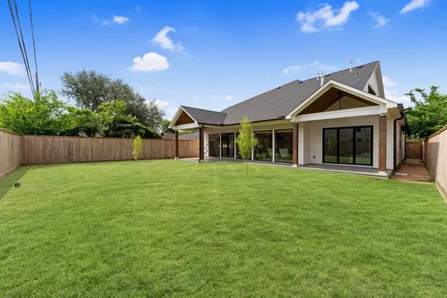 a front view of house with a garden