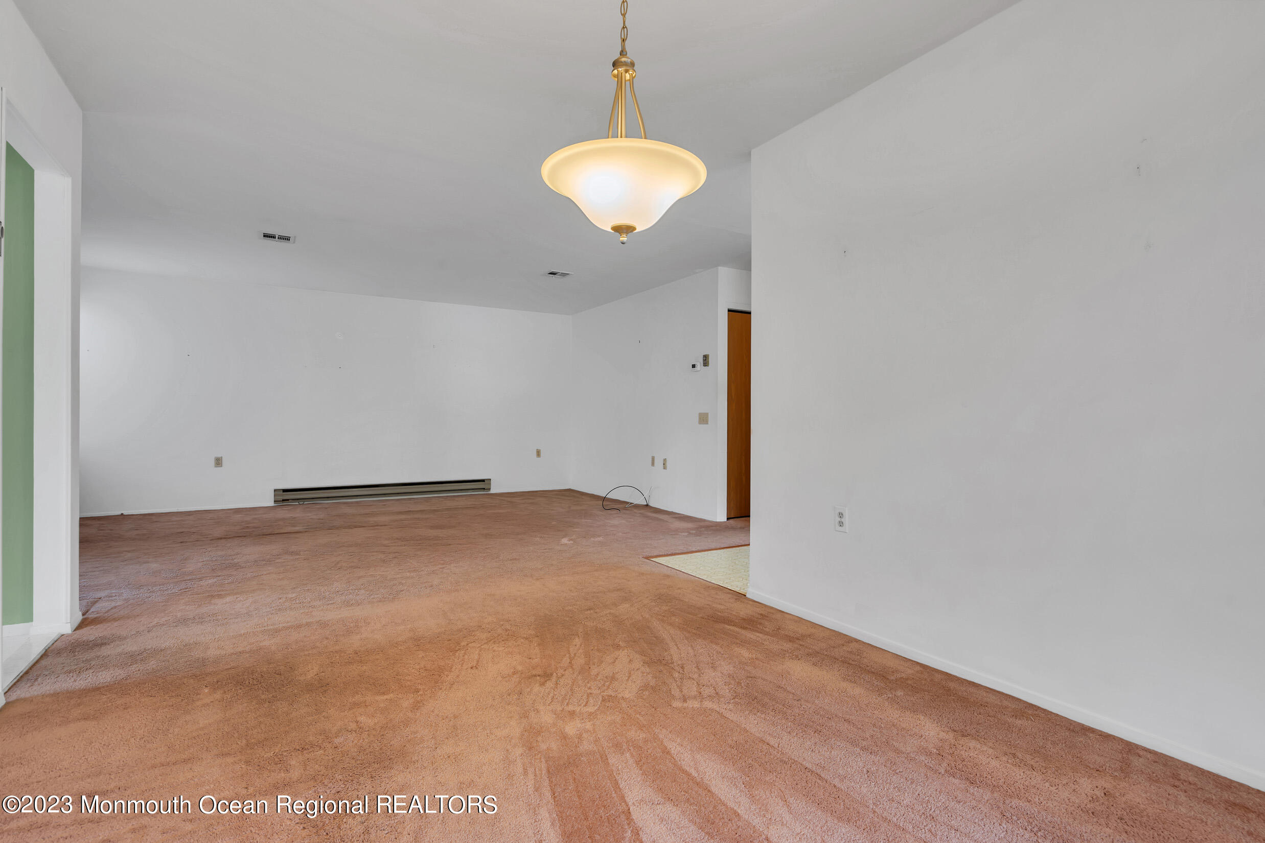 11 A Amherst Road Whiting, NJ 08759 - Photo 10 of 31 a view of a room with a chandelier fan and wooden floor