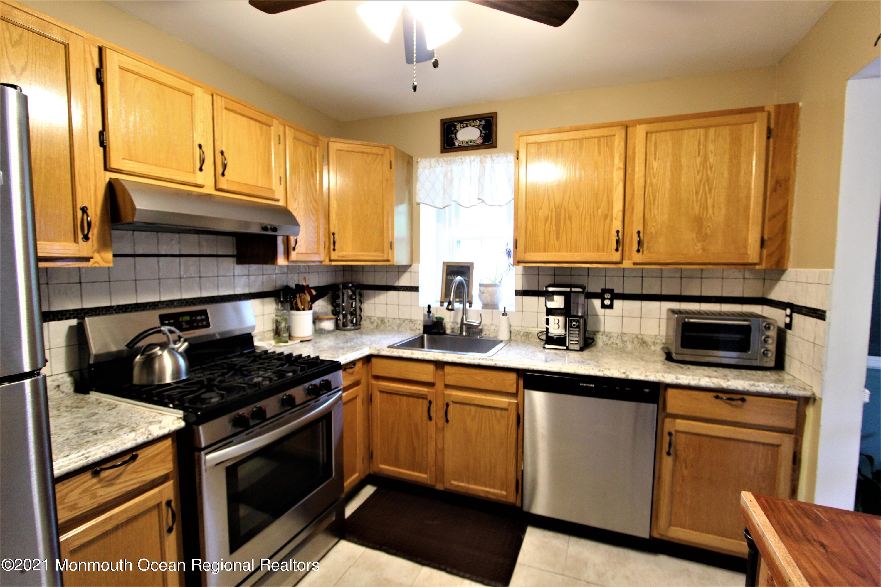 231 Atlantic Street, Unit 48 Keyport, NJ 07735 - Photo 15 of 32 a kitchen with stainless steel appliances a sink stove and cabinets