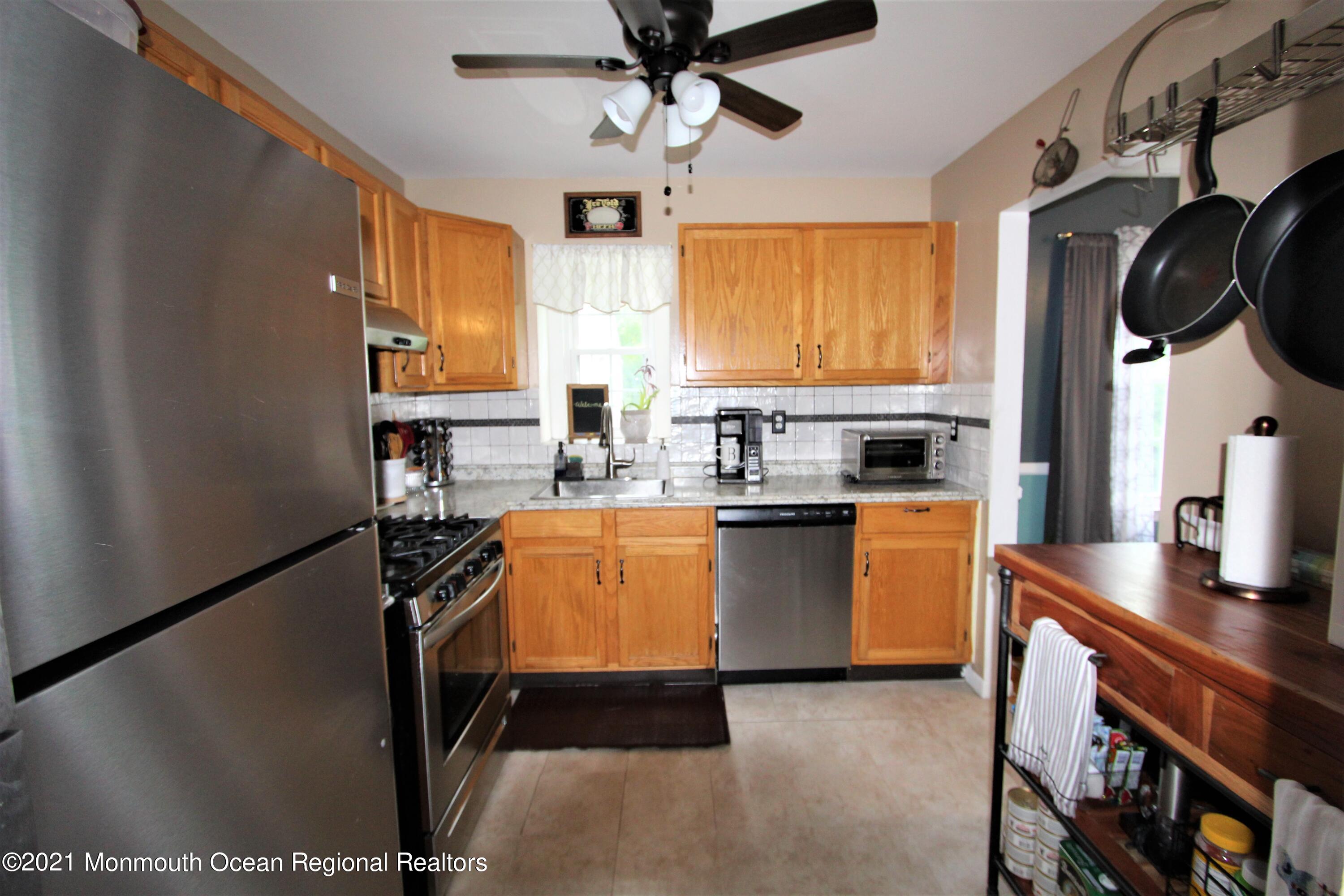 231 Atlantic Street, Unit 48 Keyport, NJ 07735 - Photo 17 of 32 a kitchen with stainless steel appliances a sink stove and window