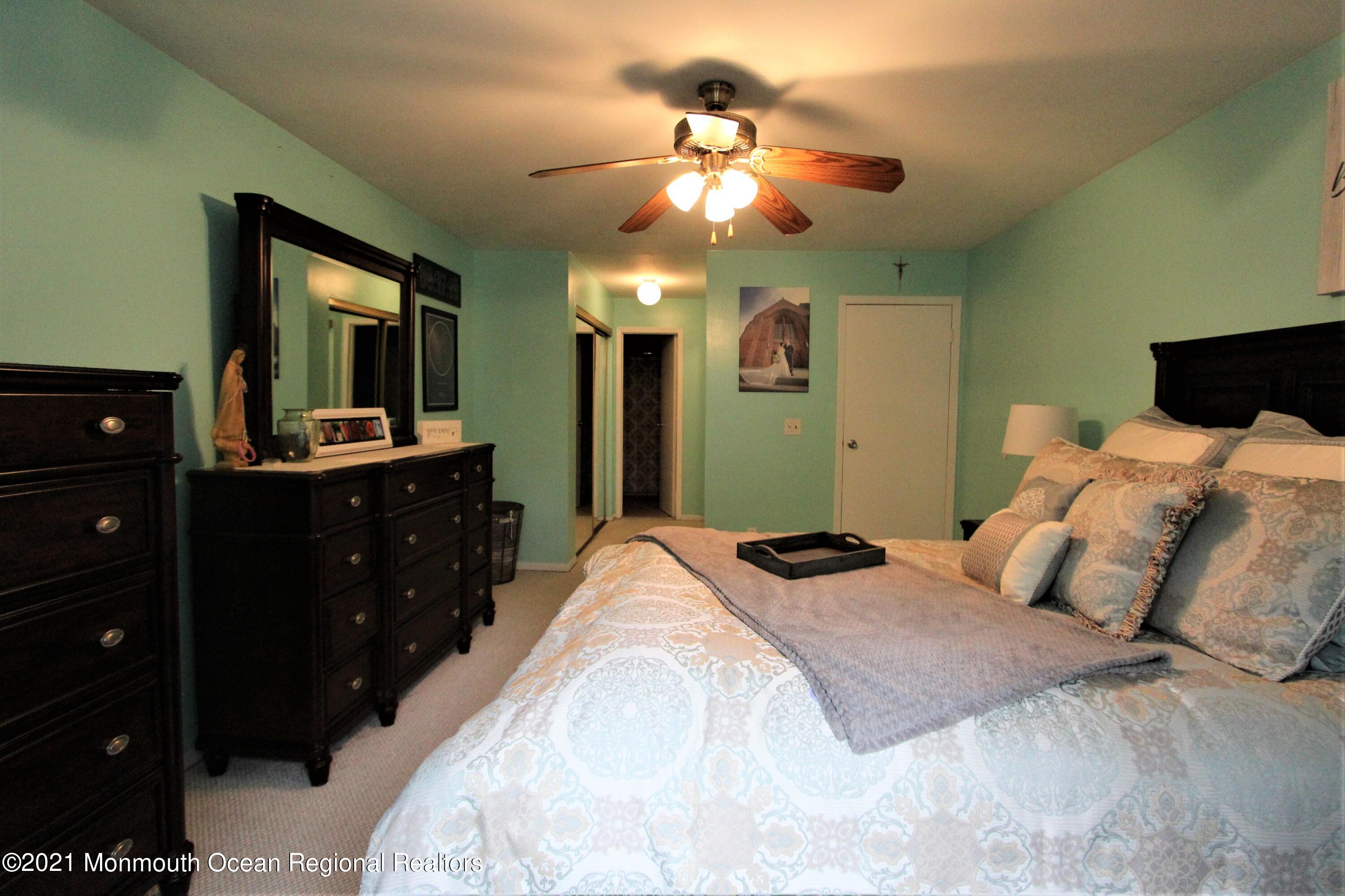 231 Atlantic Street, Unit 48 Keyport, NJ 07735 - Photo 19 of 32 a bedroom with a bed and a mirror