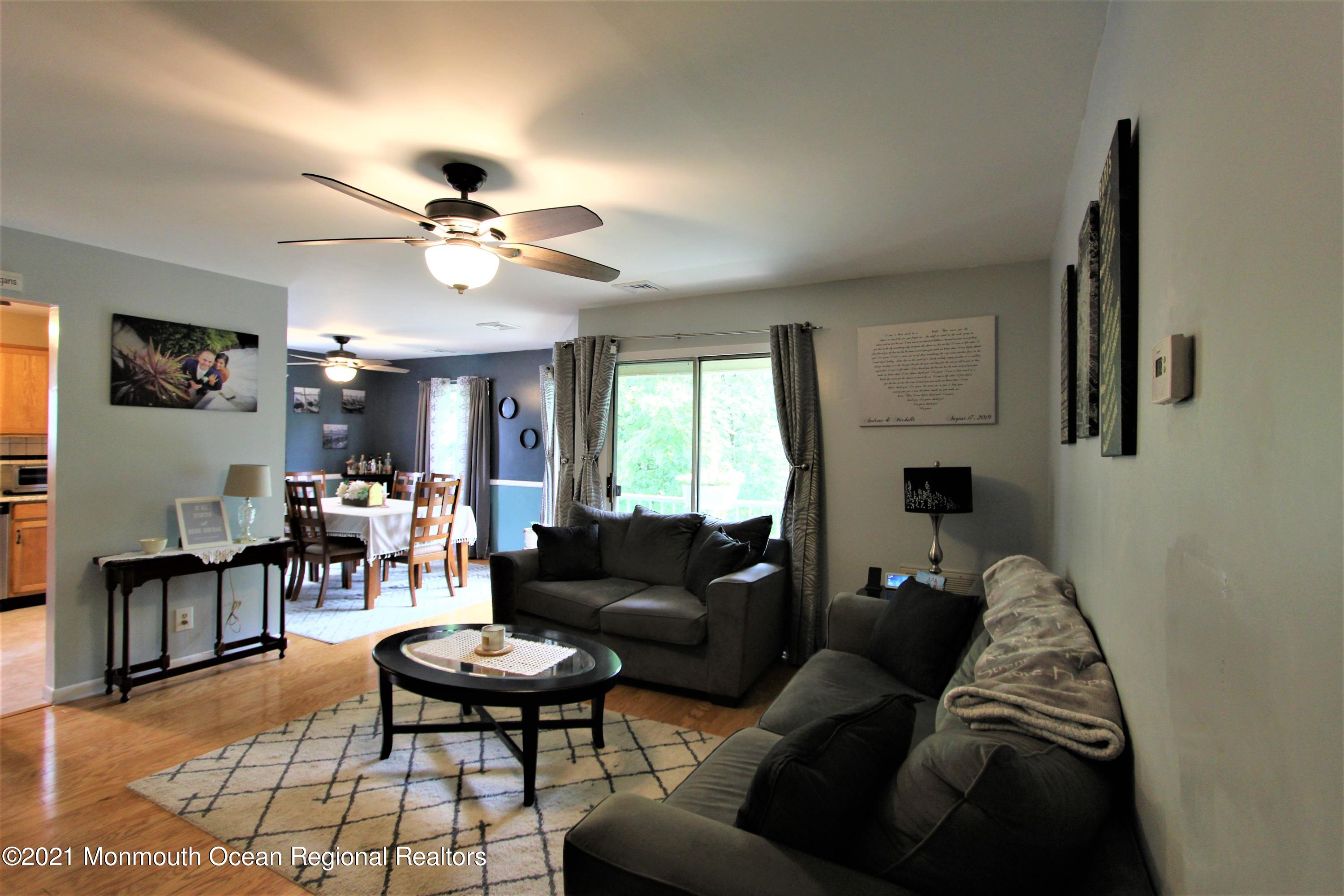 231 Atlantic Street, Unit 48 Keyport, NJ 07735 - Photo 3 of 32 a living room with furniture and wooden floor