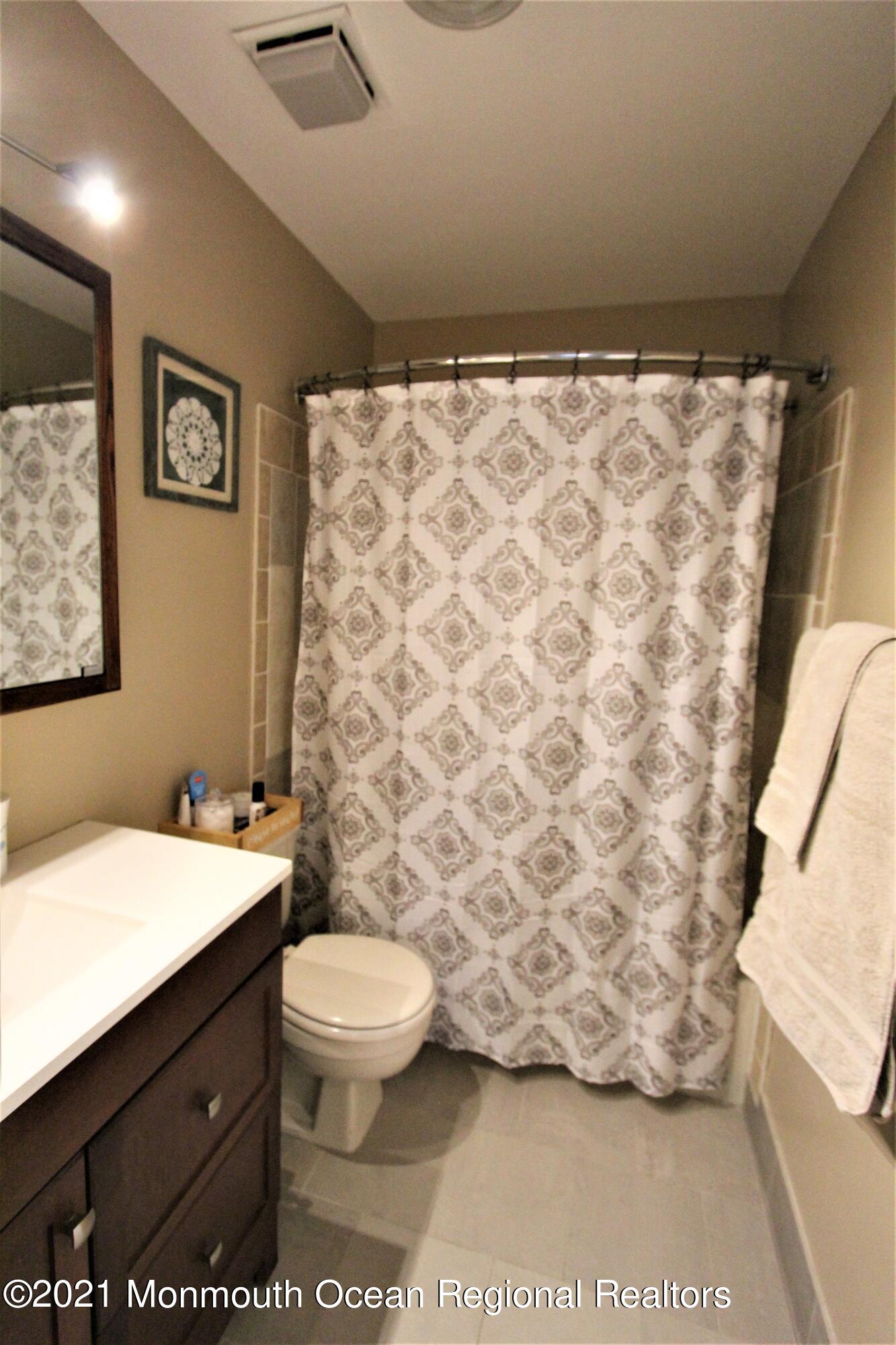 231 Atlantic Street, Unit 48 Keyport, NJ 07735 - Photo 23 of 32 a bathroom with a sink toilet and shower