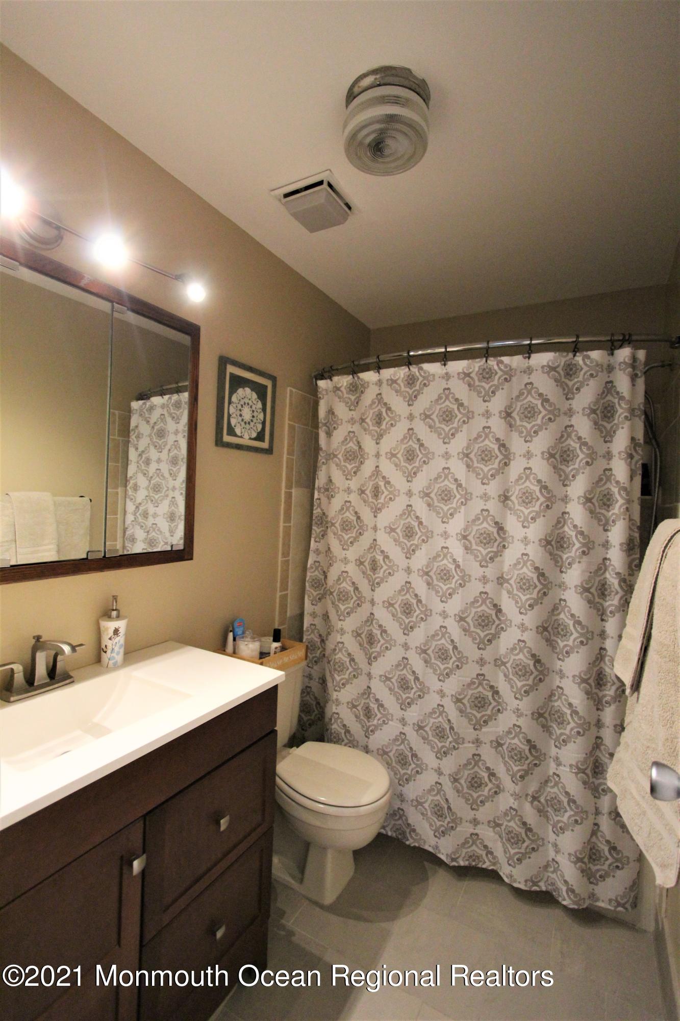 231 Atlantic Street, Unit 48 Keyport, NJ 07735 - Photo 24 of 32 a bathroom with a sink toilet and shower