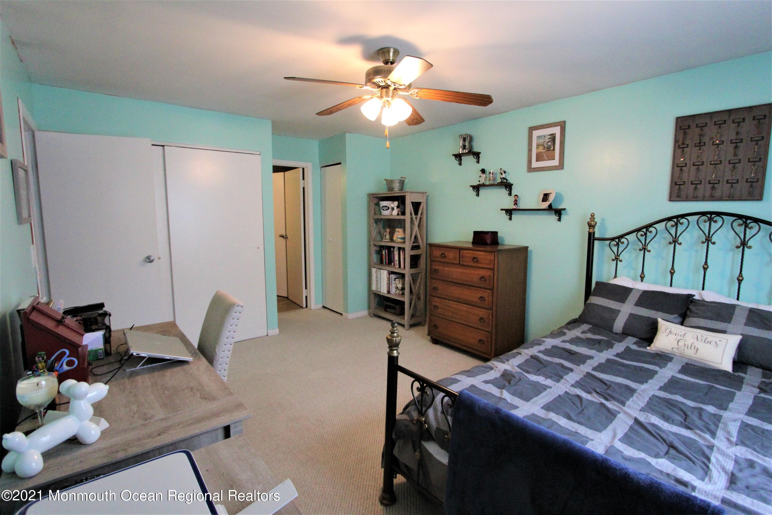 231 Atlantic Street, Unit 48 Keyport, NJ 07735 - Photo 27 of 32 a bedroom with a bed and furniture