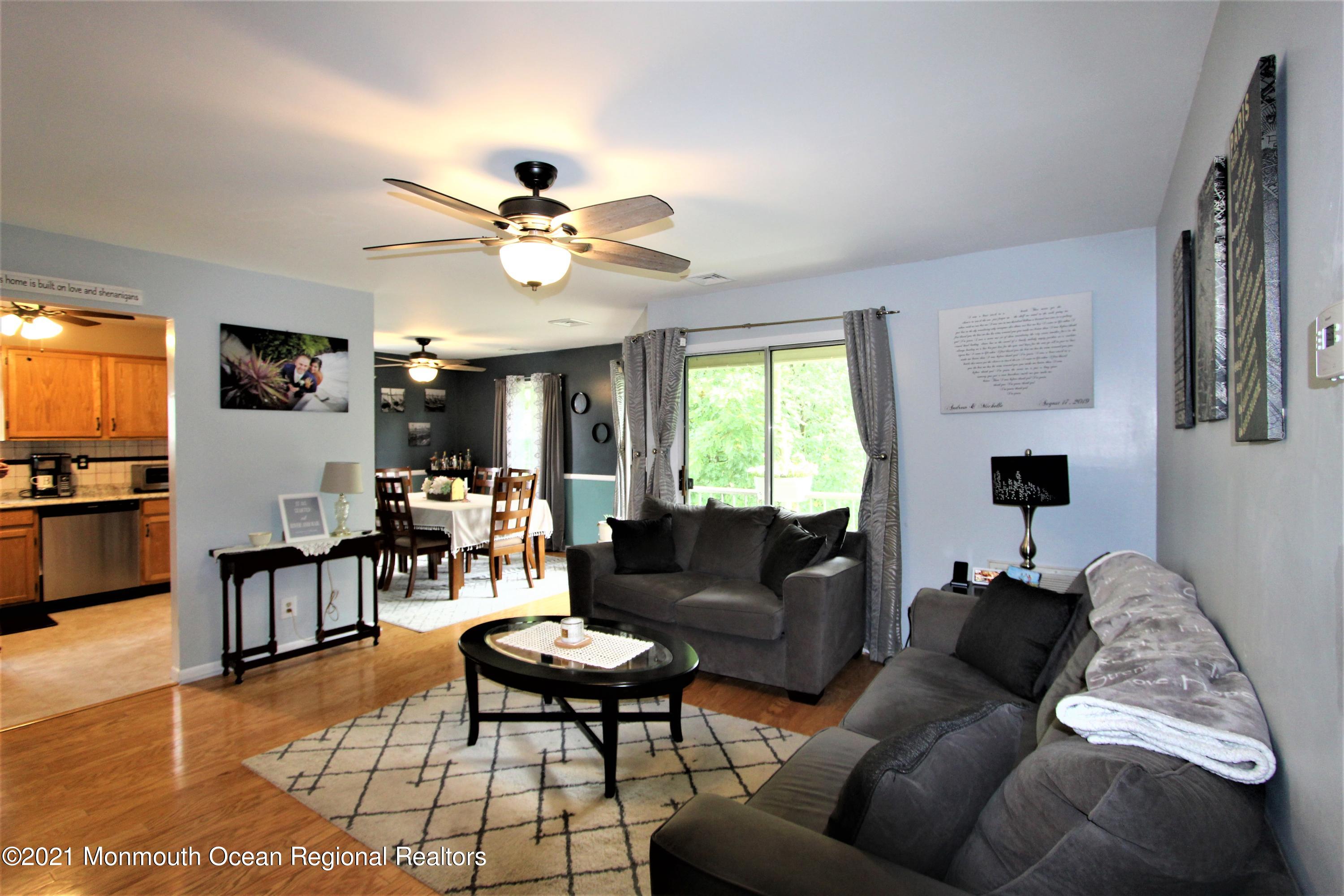 231 Atlantic Street, Unit 48 Keyport, NJ 07735 - Photo 4 of 32 a living room with furniture a fireplace and a flat screen tv