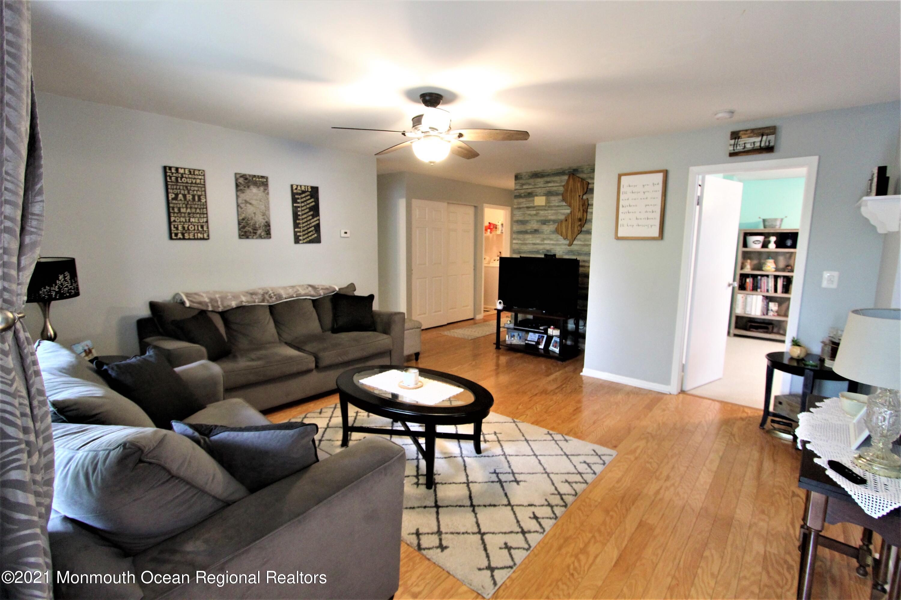 231 Atlantic Street, Unit 48 Keyport, NJ 07735 - Photo 5 of 32 a living room with furniture and a flat screen tv