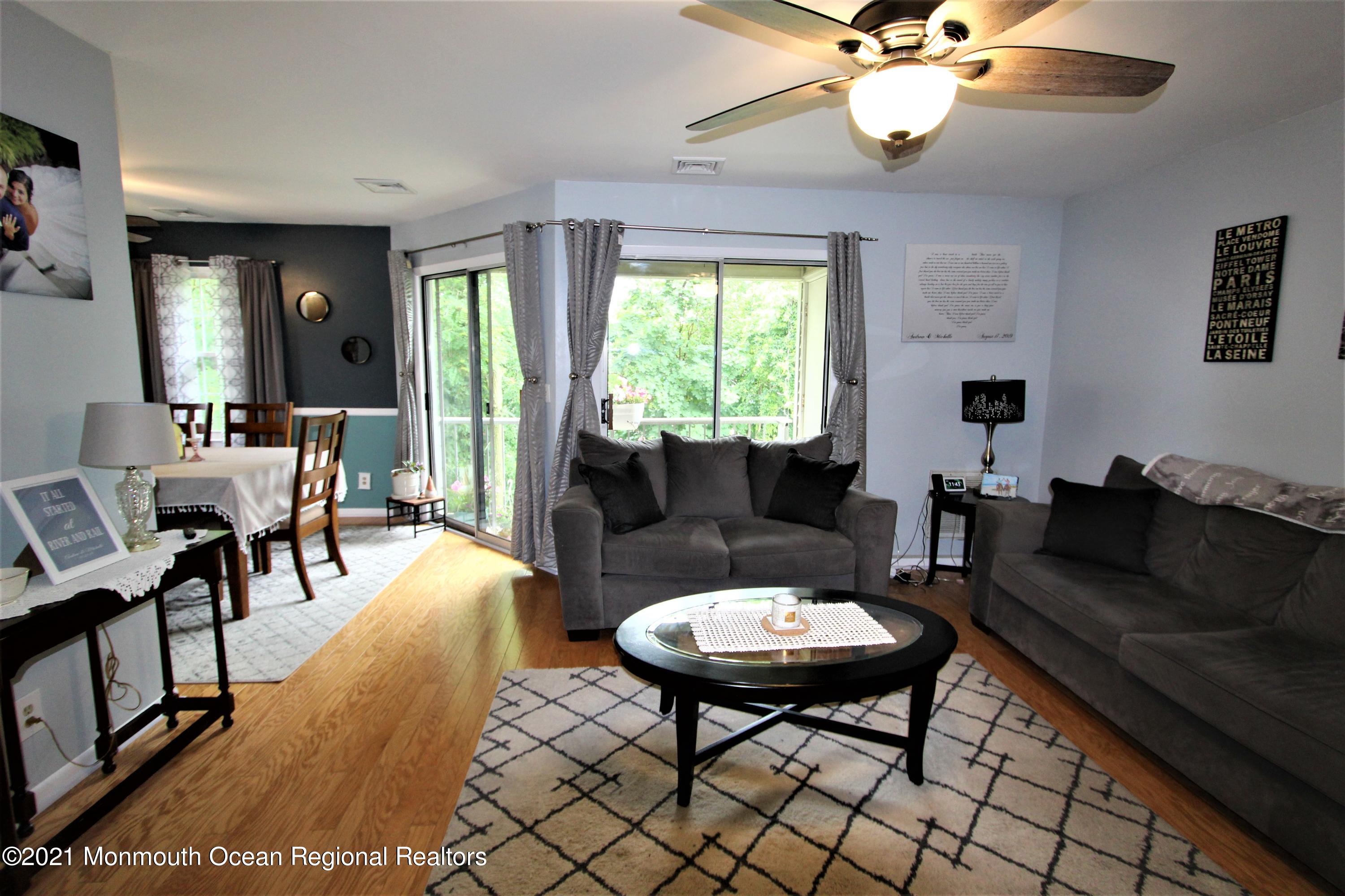 231 Atlantic Street, Unit 48 Keyport, NJ 07735 - Photo 6 of 32 a living room with furniture two window and a table