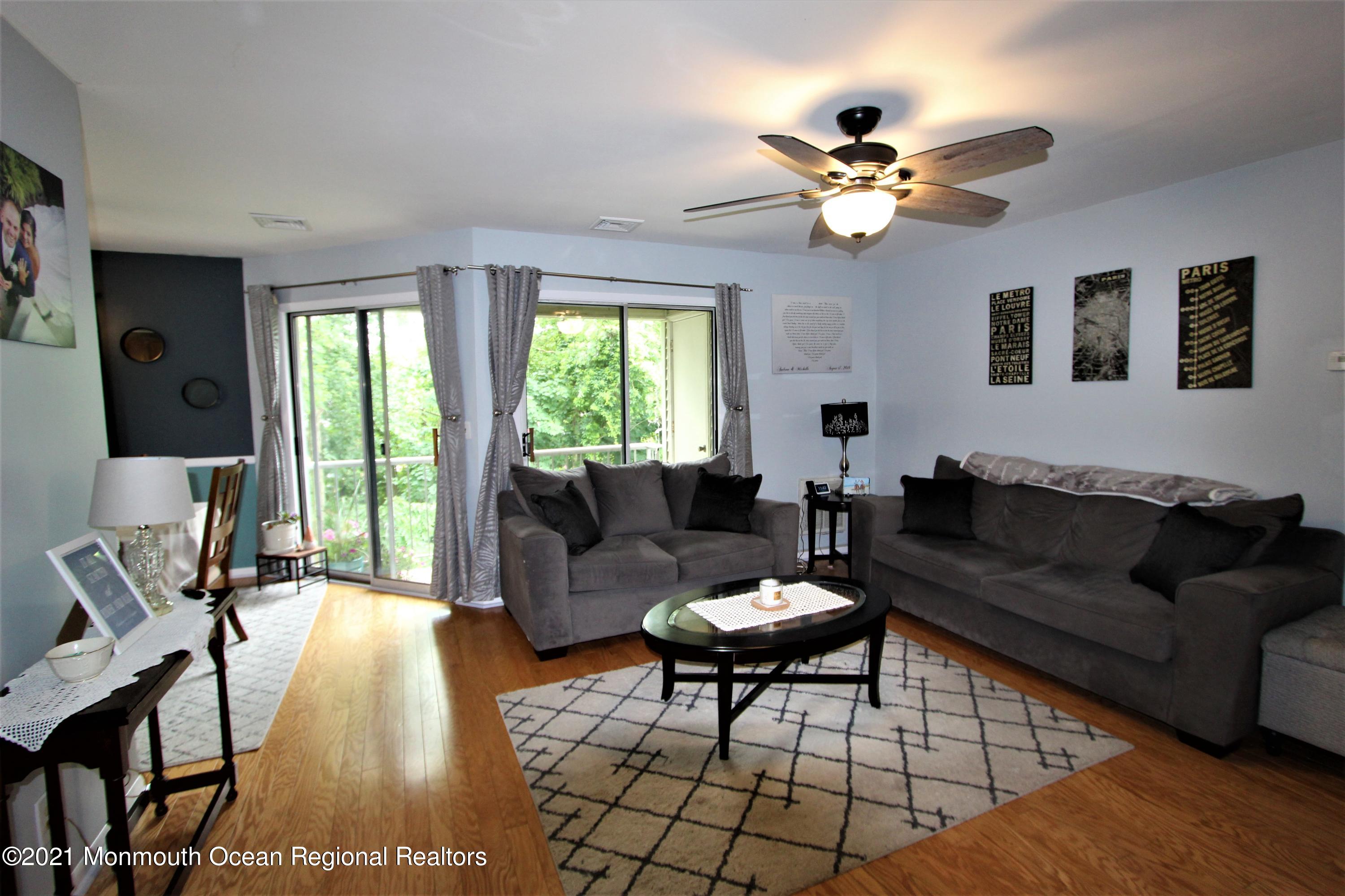 231 Atlantic Street, Unit 48 Keyport, NJ 07735 - Photo 7 of 32 a living room with furniture and a chandelier
