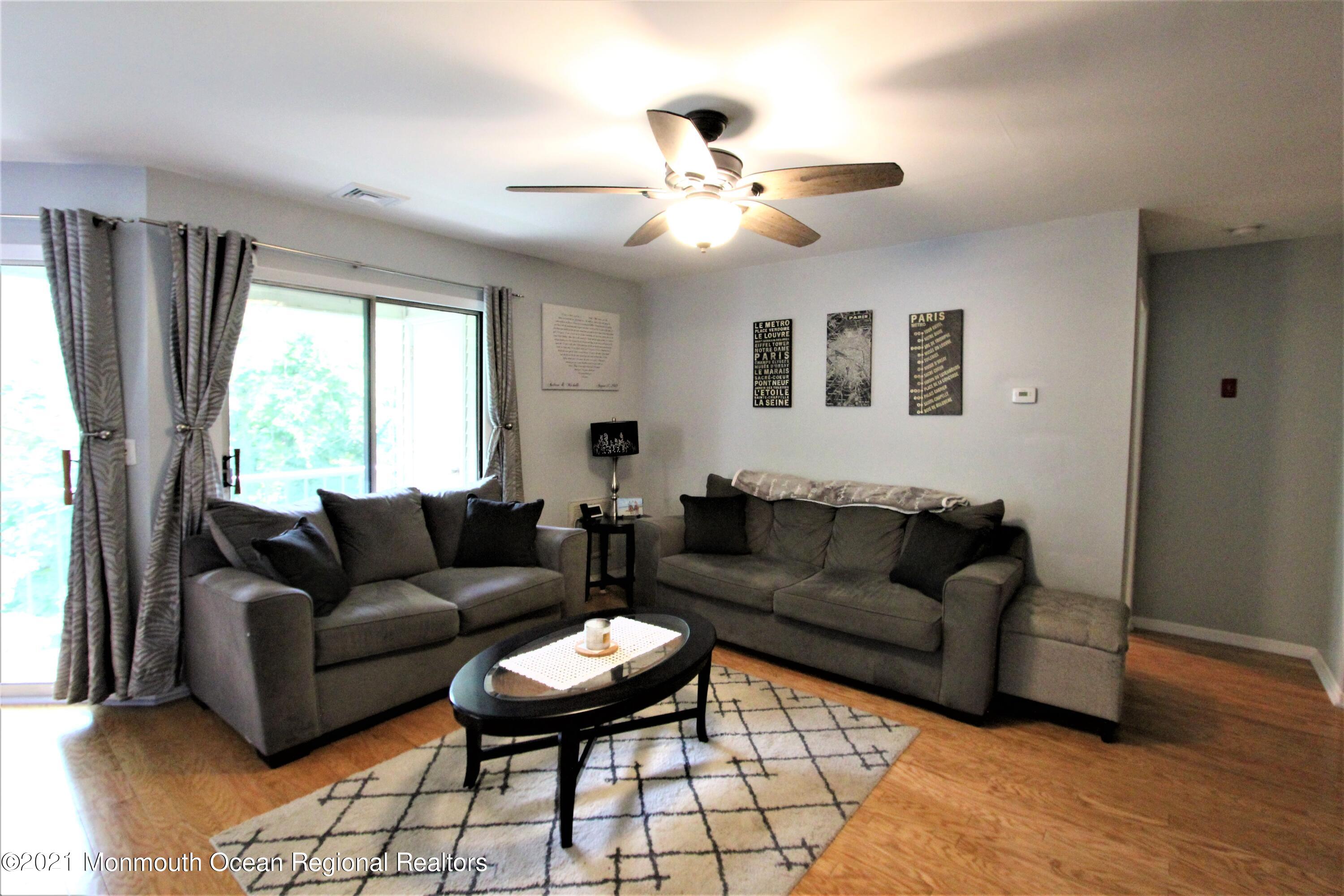 231 Atlantic Street, Unit 48 Keyport, NJ 07735 - Photo 8 of 32 a living room with furniture and a large window