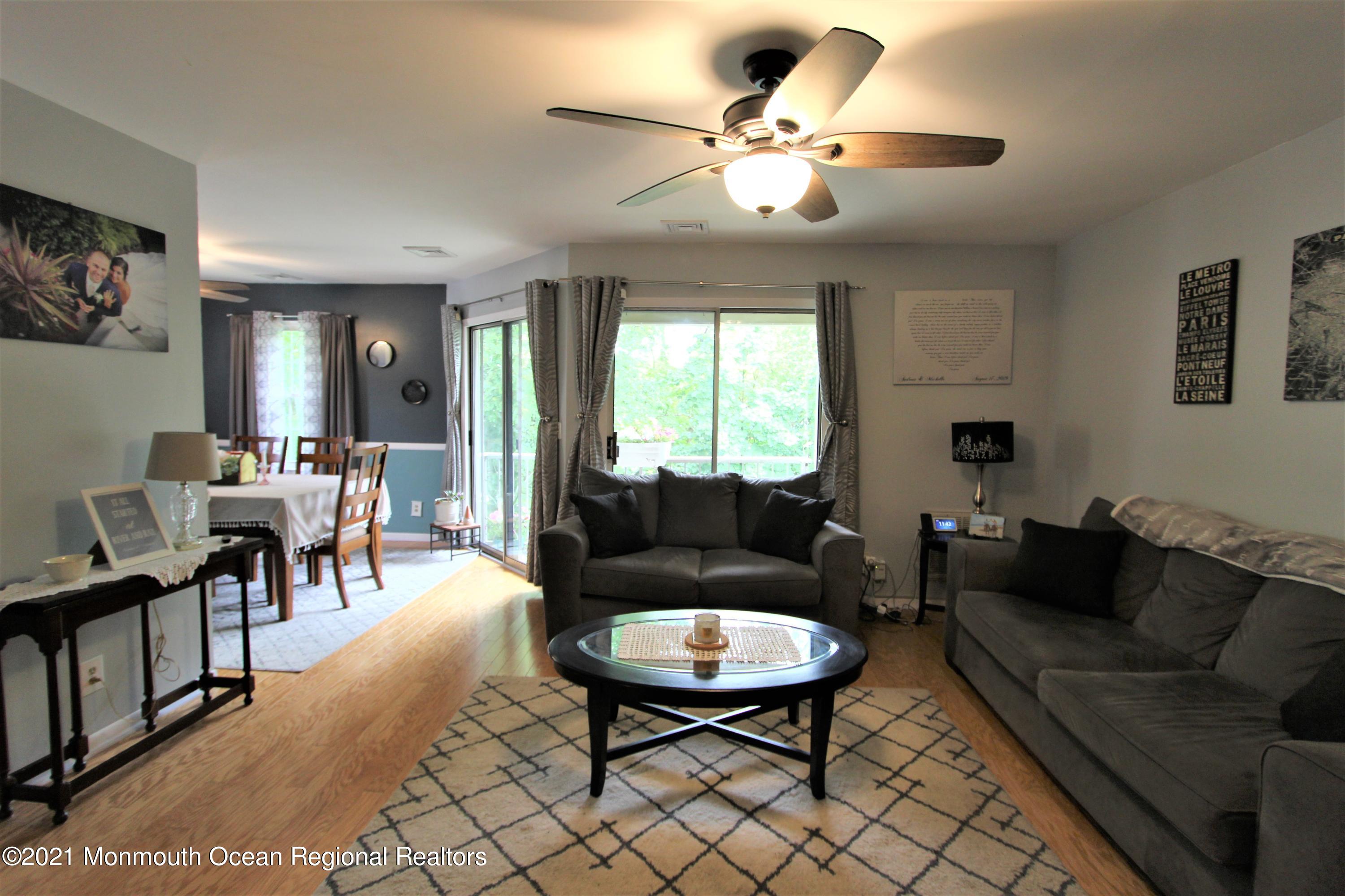 231 Atlantic Street, Unit 48 Keyport, NJ 07735 - Photo 9 of 32 a living room with furniture kitchen view and a large window