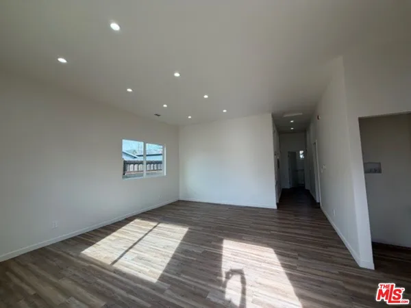 a view of an empty room and a window