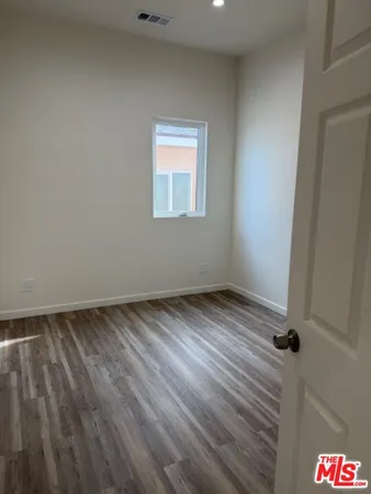 an empty room with wooden floor
