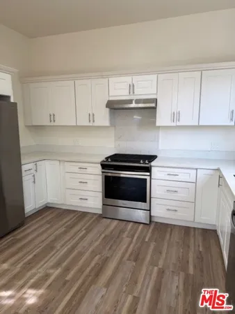 a kitchen with stainless steel appliances a refrigerator and cabinets