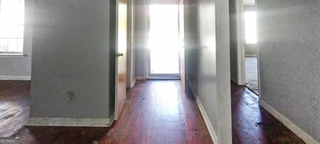 a view of a hallway with wooden floor