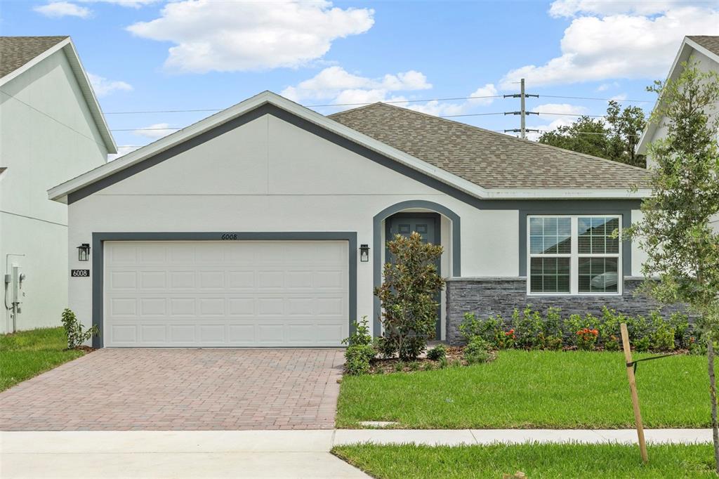 6008 Vision Road St. Cloud, FL 34771 - Photo 1 of 1 a front view of a house with a yard