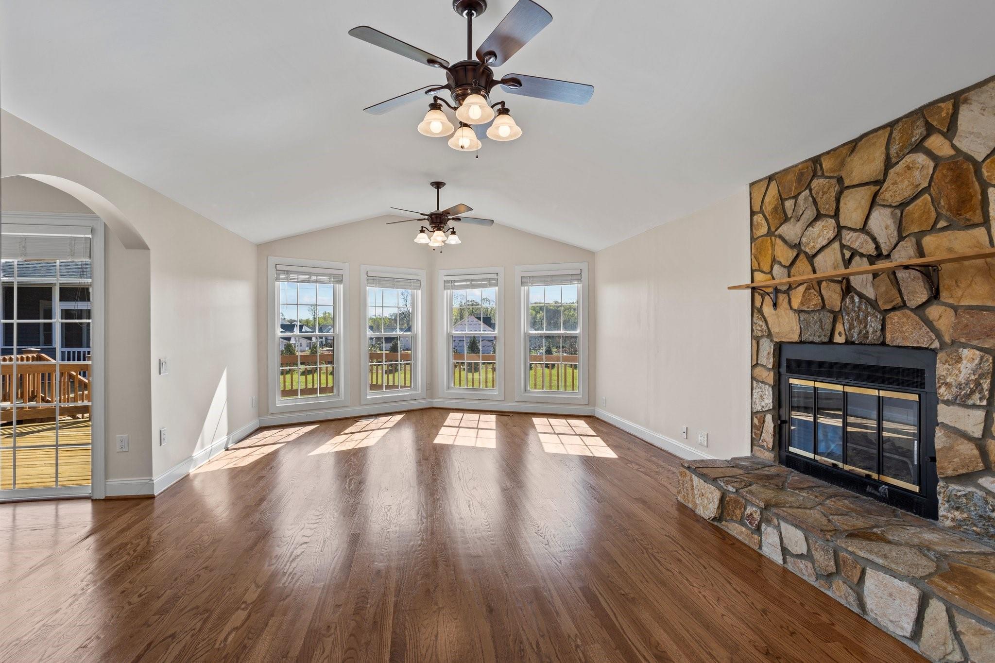 15020 Ranson Road, Unit A Huntersville, NC 28078 - Photo 11 of 25 a view of an empty room with wooden floor fireplace and a window