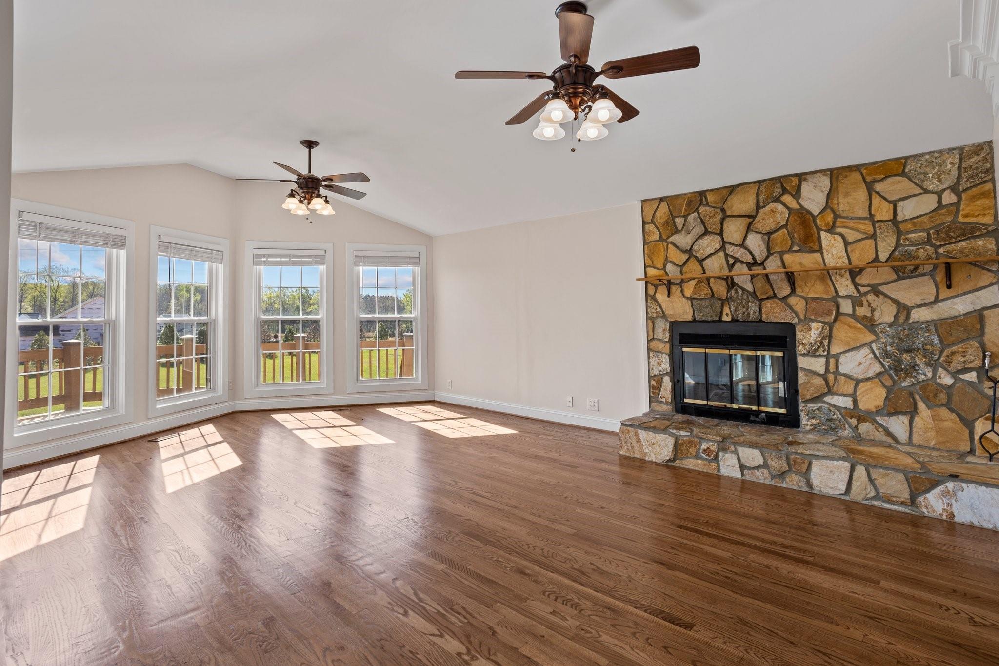 15020 Ranson Road, Unit A Huntersville, NC 28078 - Photo 12 of 25 a view of an empty room with wooden floor and a window