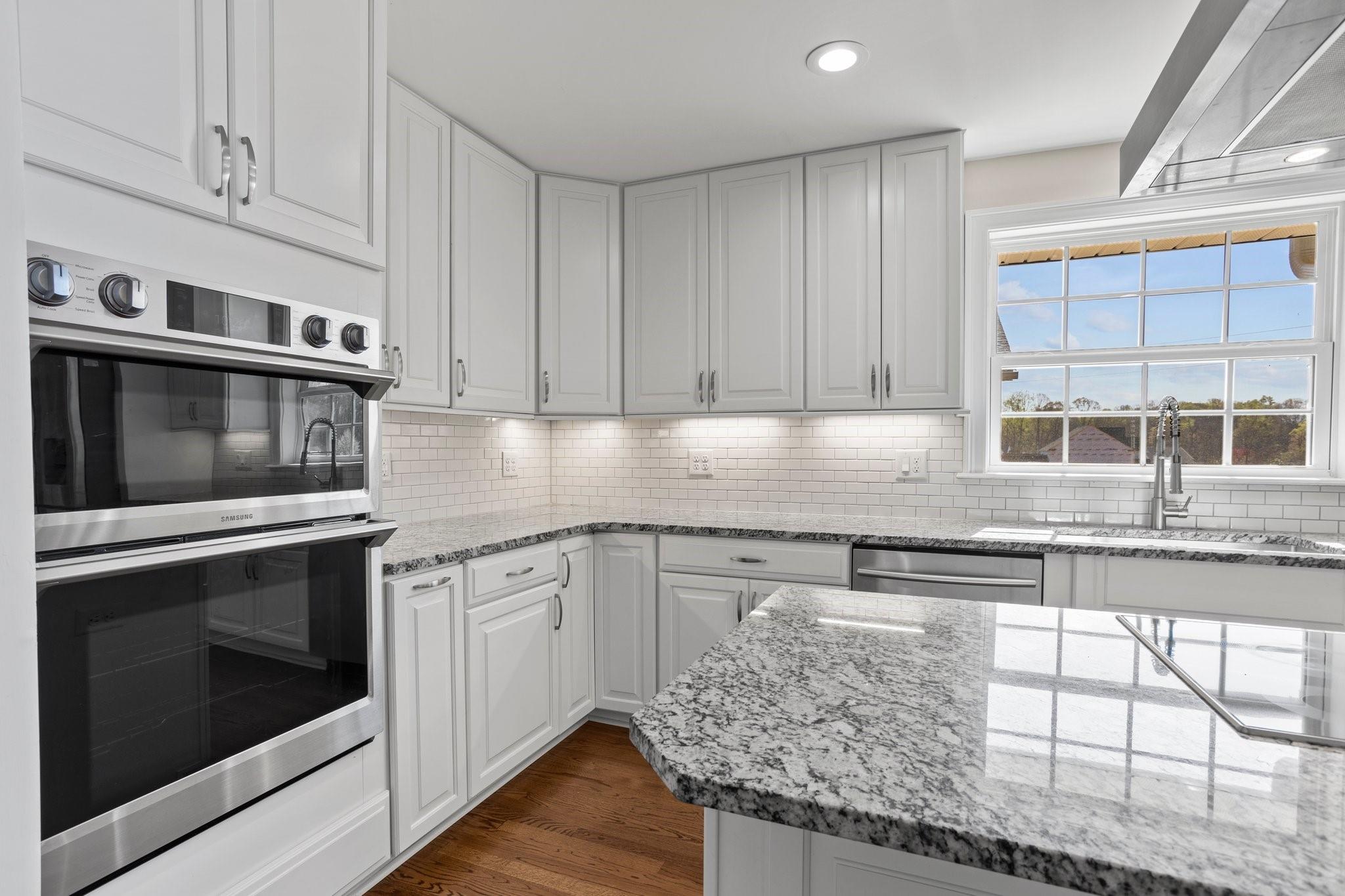 15020 Ranson Road, Unit A Huntersville, NC 28078 - Photo 17 of 25 a kitchen with stainless steel appliances granite countertop a stove a sink and a microwave