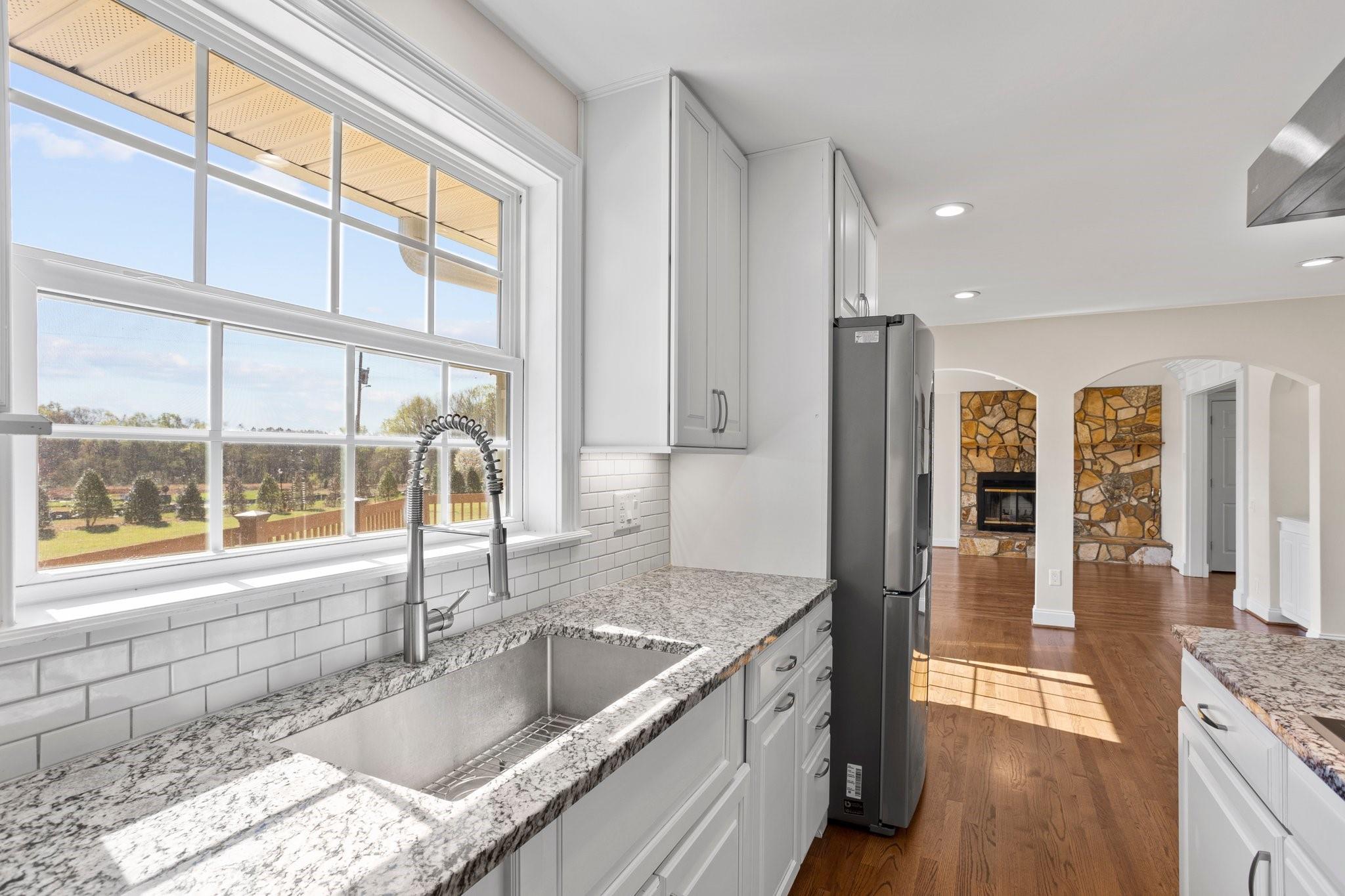 15020 Ranson Road, Unit A Huntersville, NC 28078 - Photo 18 of 25 a kitchen with granite countertop a sink and a refrigerator
