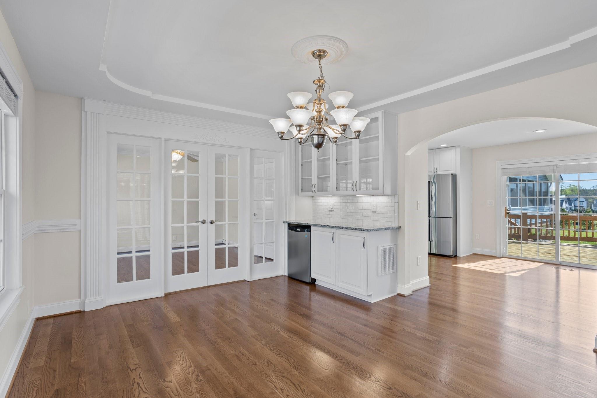 15020 Ranson Road, Unit A Huntersville, NC 28078 - Photo 20 of 25 a view of an empty room with wooden floor and a kitchen