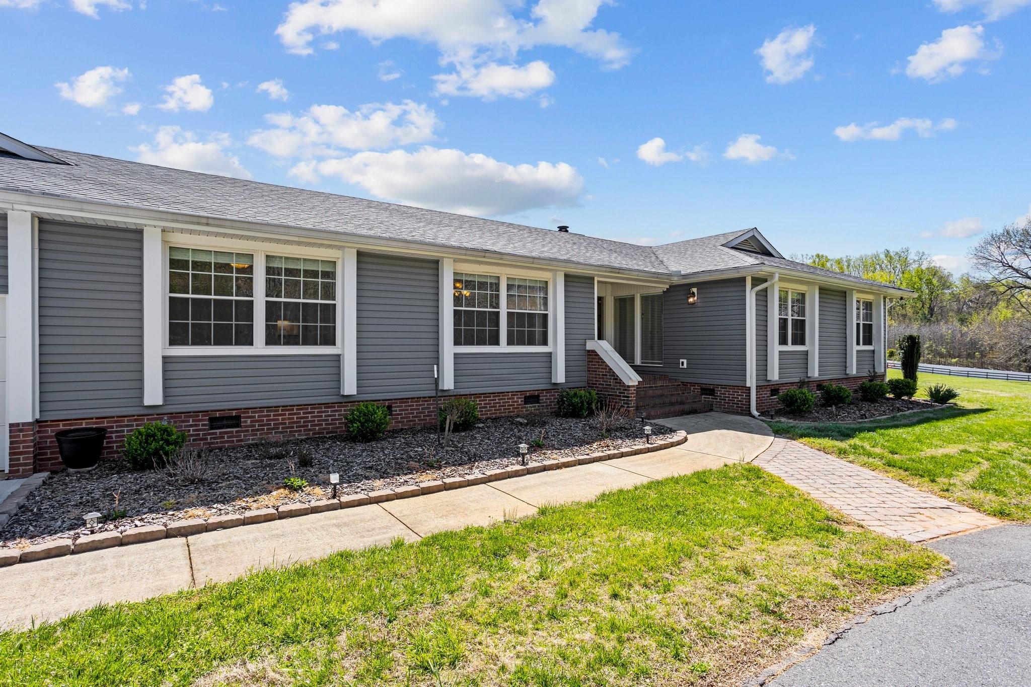15020 Ranson Road, Unit A Huntersville, NC 28078 - Photo 2 of 25 a front view of a house with garden
