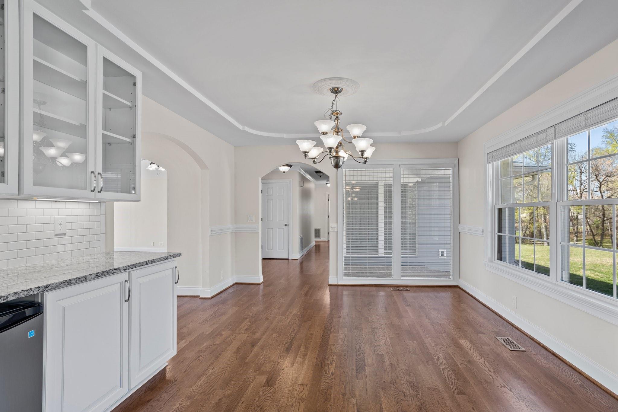 15020 Ranson Road, Unit A Huntersville, NC 28078 - Photo 21 of 25 a view of a hallway with wooden floor and a kitchen