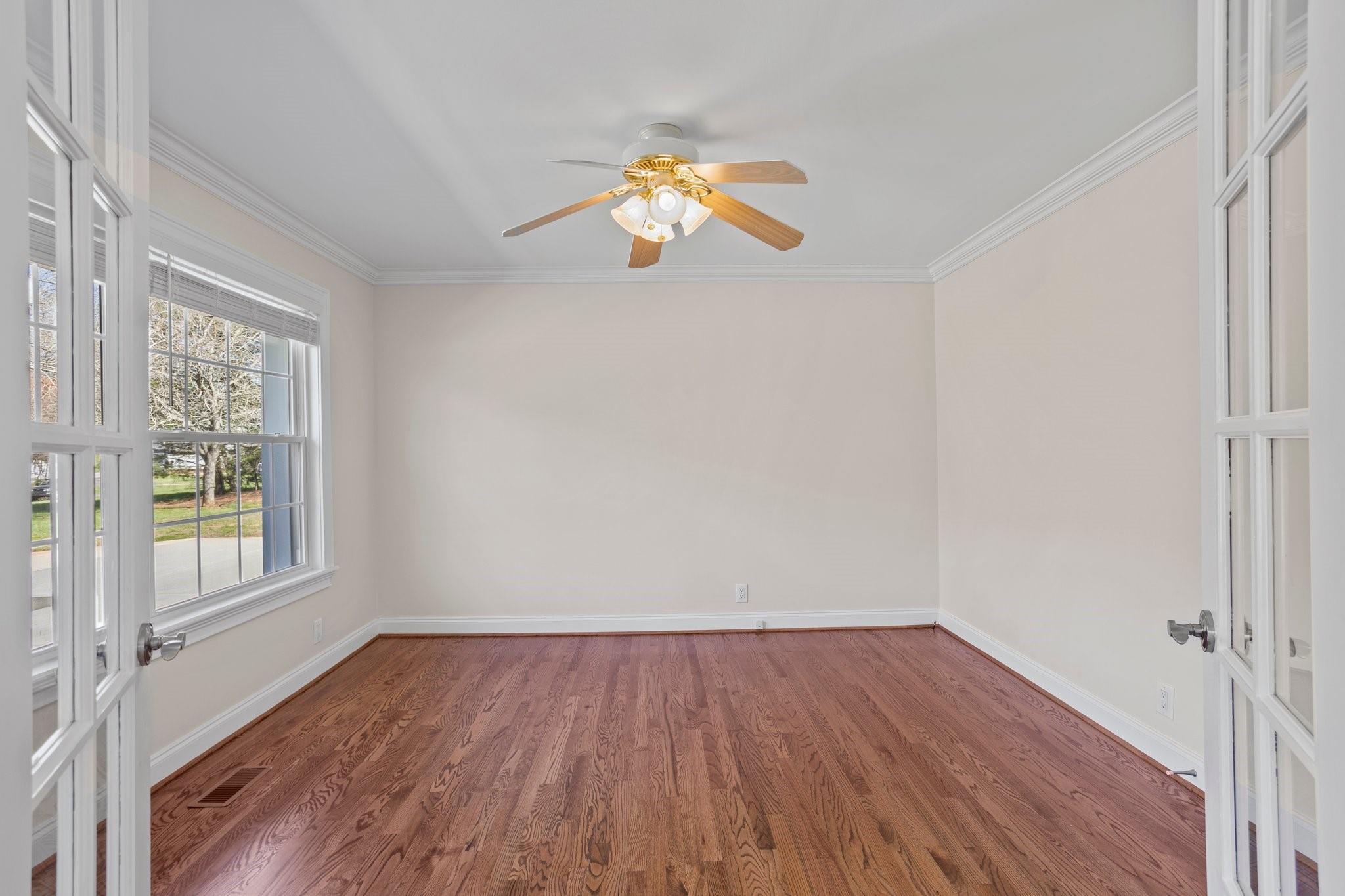 15020 Ranson Road, Unit A Huntersville, NC 28078 - Photo 22 of 25 an empty room with wooden floor and windows