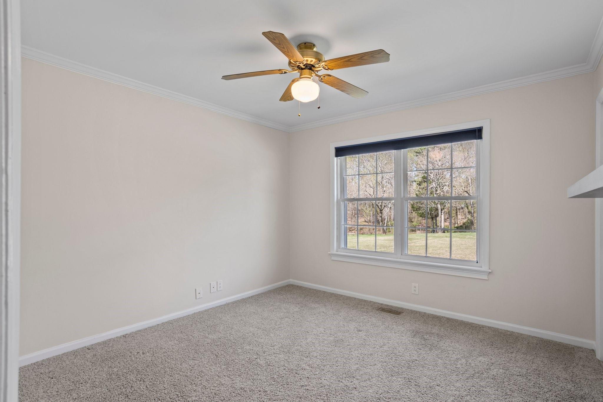 15020 Ranson Road, Unit A Huntersville, NC 28078 - Photo 23 of 25 an empty room with a window and a ceiling fan