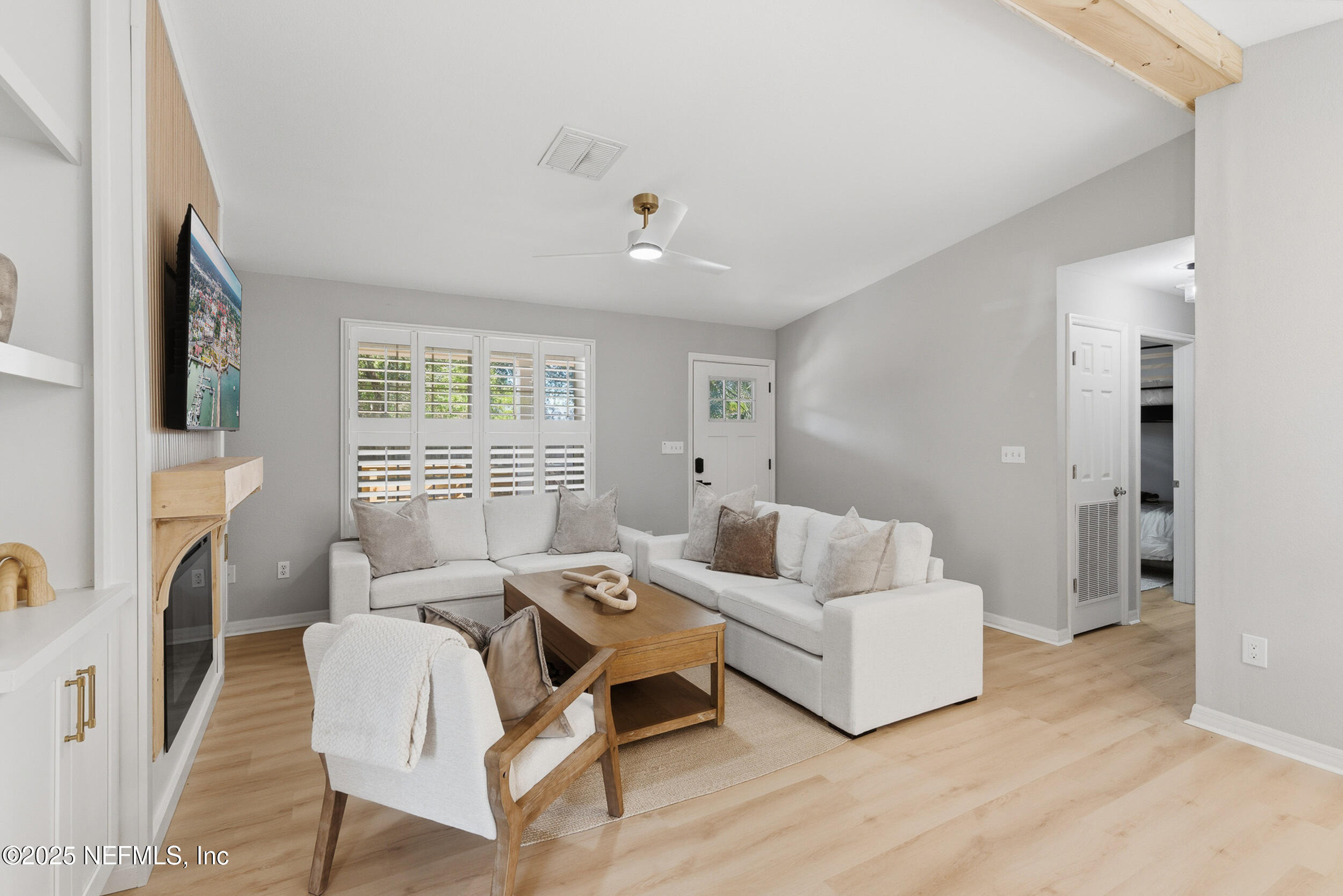 2 A Moultrie Place St. Augustine, FL 32080 - Photo 13 of 69 a living room with furniture a fireplace and a large window