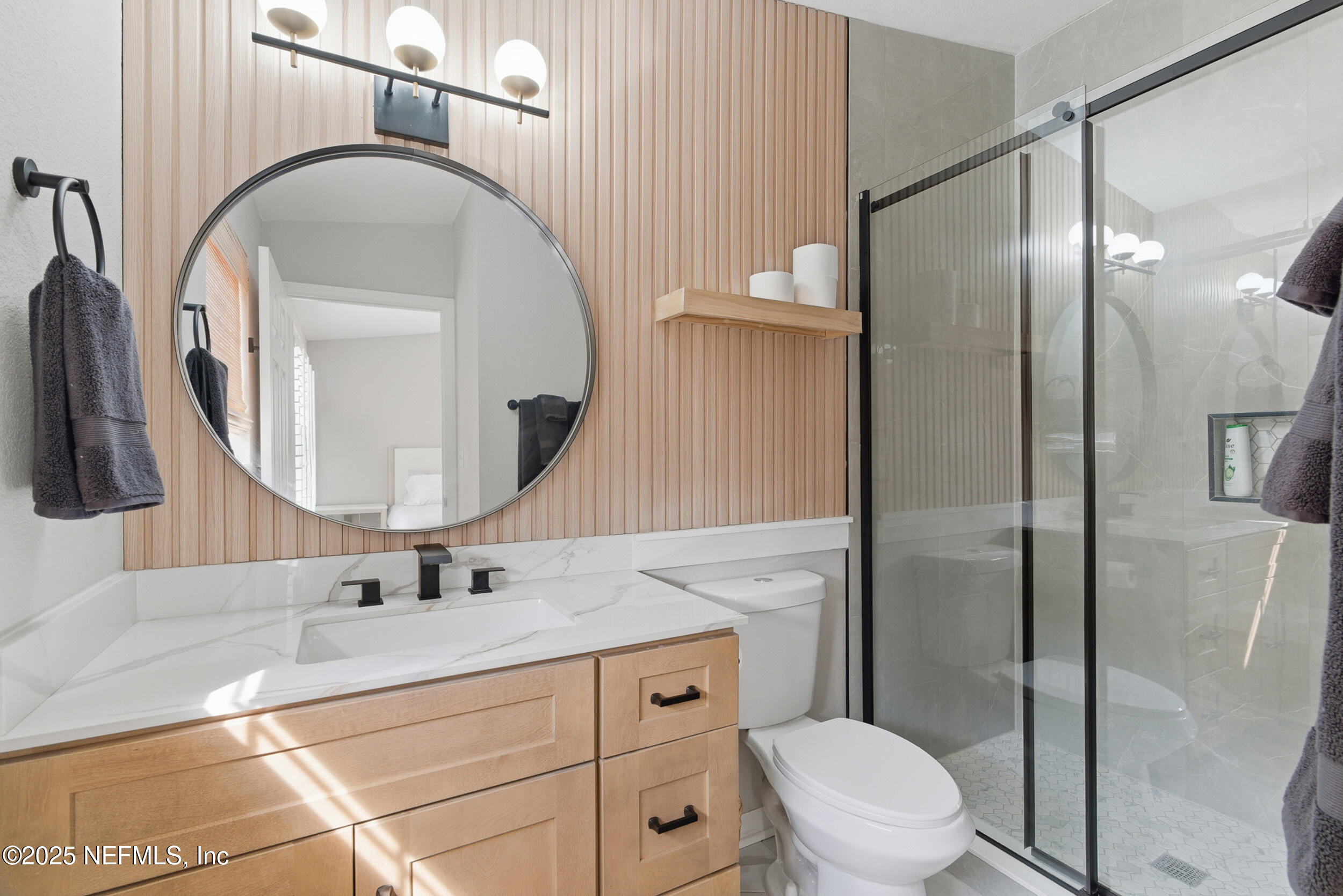 2 A Moultrie Place St. Augustine, FL 32080 - Photo 37 of 69 a bathroom with a toilet a sink and a mirror