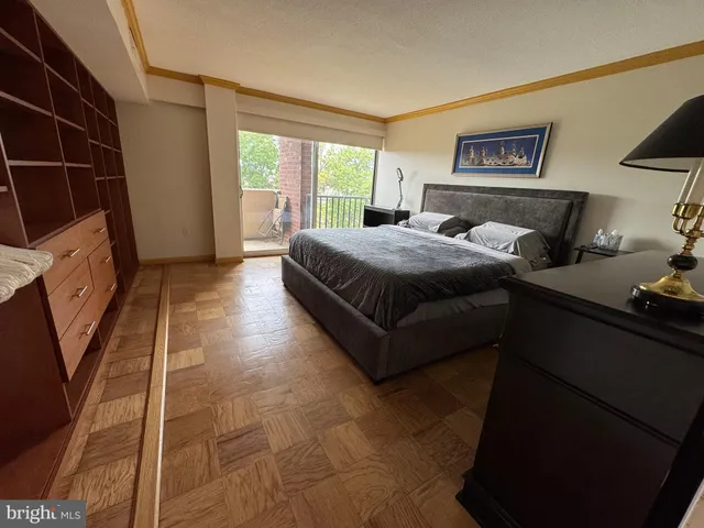 a spacious bedroom with a bed and a window