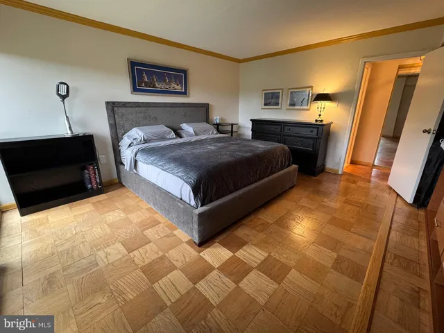 a bedroom with a bed and wooden floor