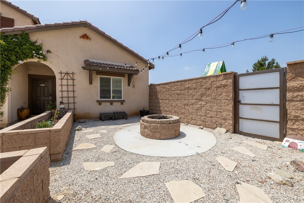 6838 Reflection Way Jurupa Valley, CA 92509 - Photo 2 of 31 FRONT YARD.. FIREPIT AREA