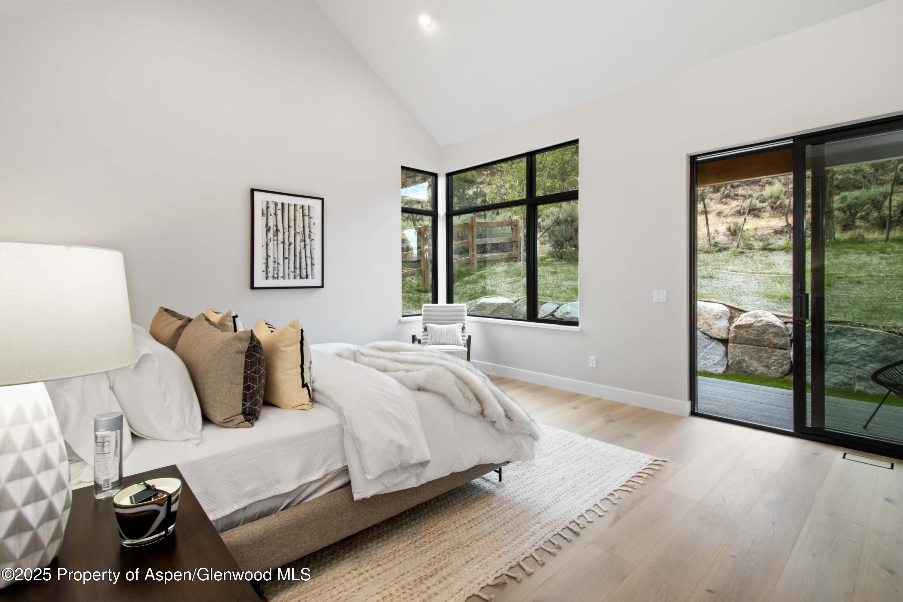 719 Perry Ridge Carbondale, CO 81623 - Photo 22 of 68 a bedroom with a bed and a large window