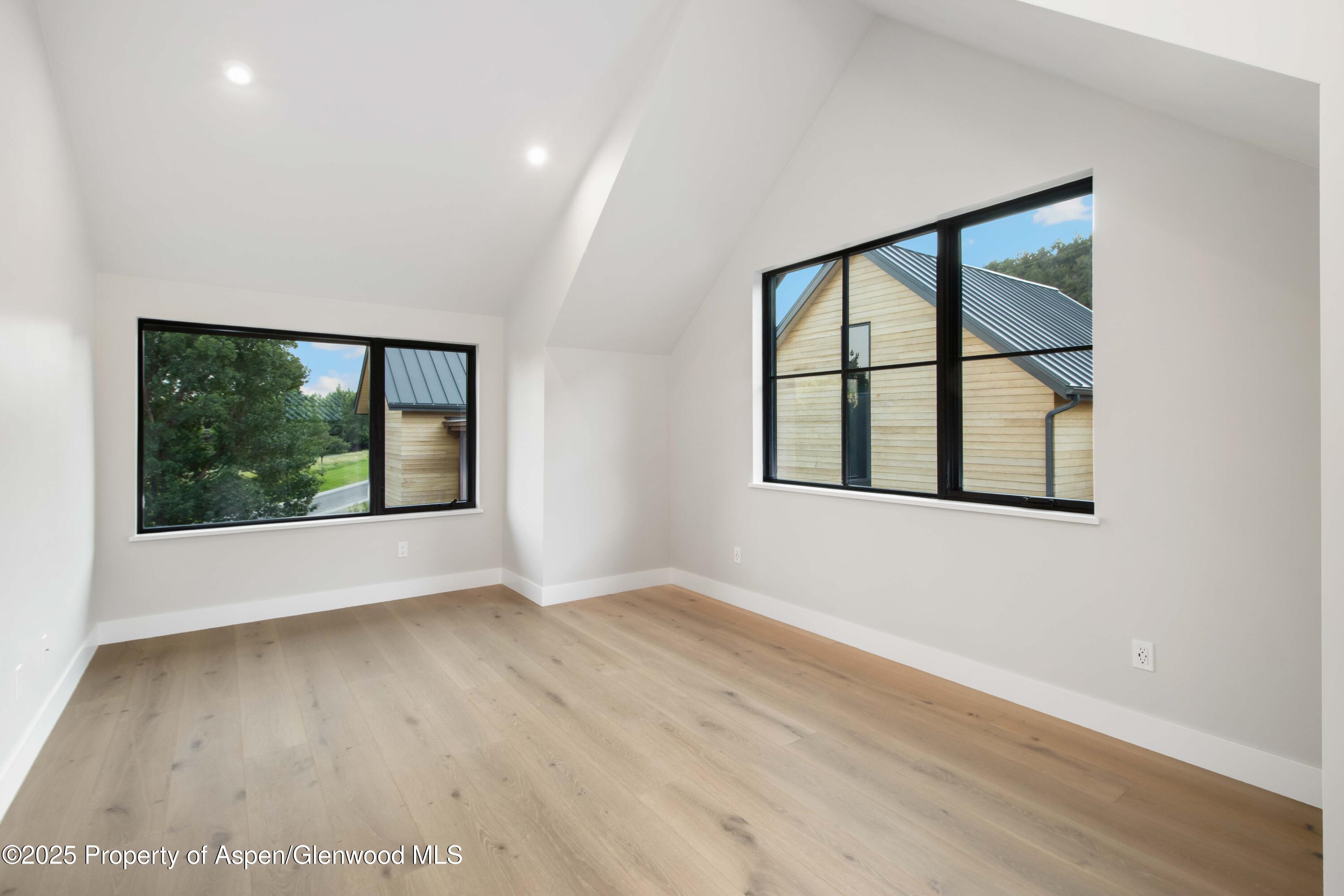 719 Perry Ridge Carbondale, CO 81623 - Photo 30 of 68 an empty room with wooden floor and windows