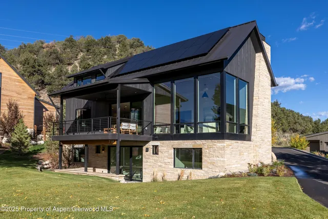 a living room with patio furniture and a floor to ceiling window