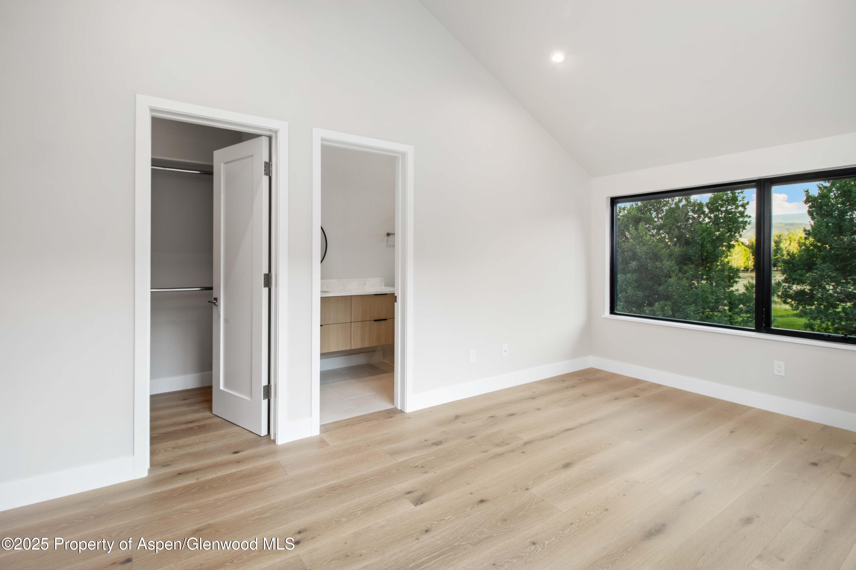 719 Perry Ridge Carbondale, CO 81623 - Photo 31 of 68 an empty room with wooden floor and windows