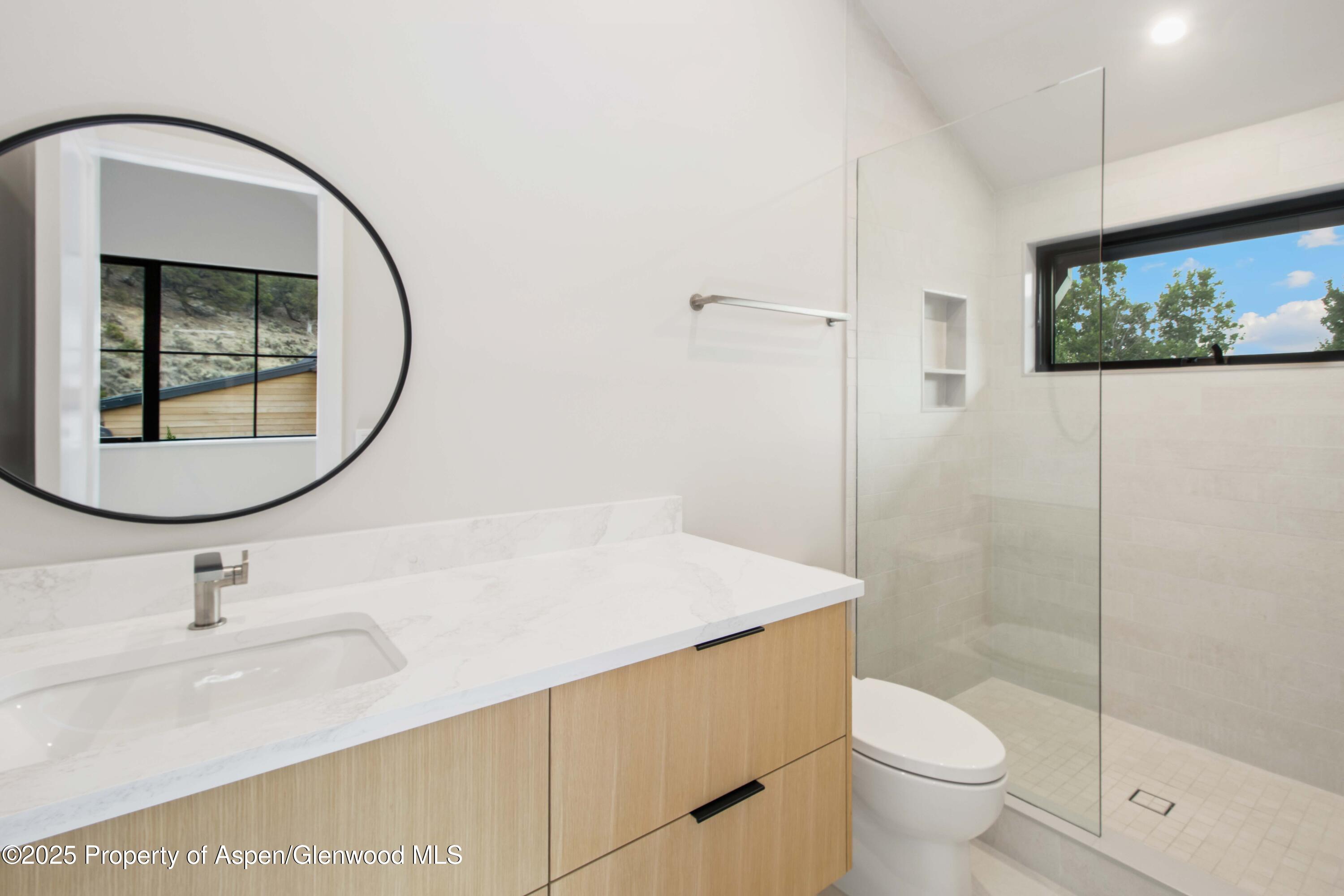719 Perry Ridge Carbondale, CO 81623 - Photo 32 of 68 a bathroom with a sink and a mirror