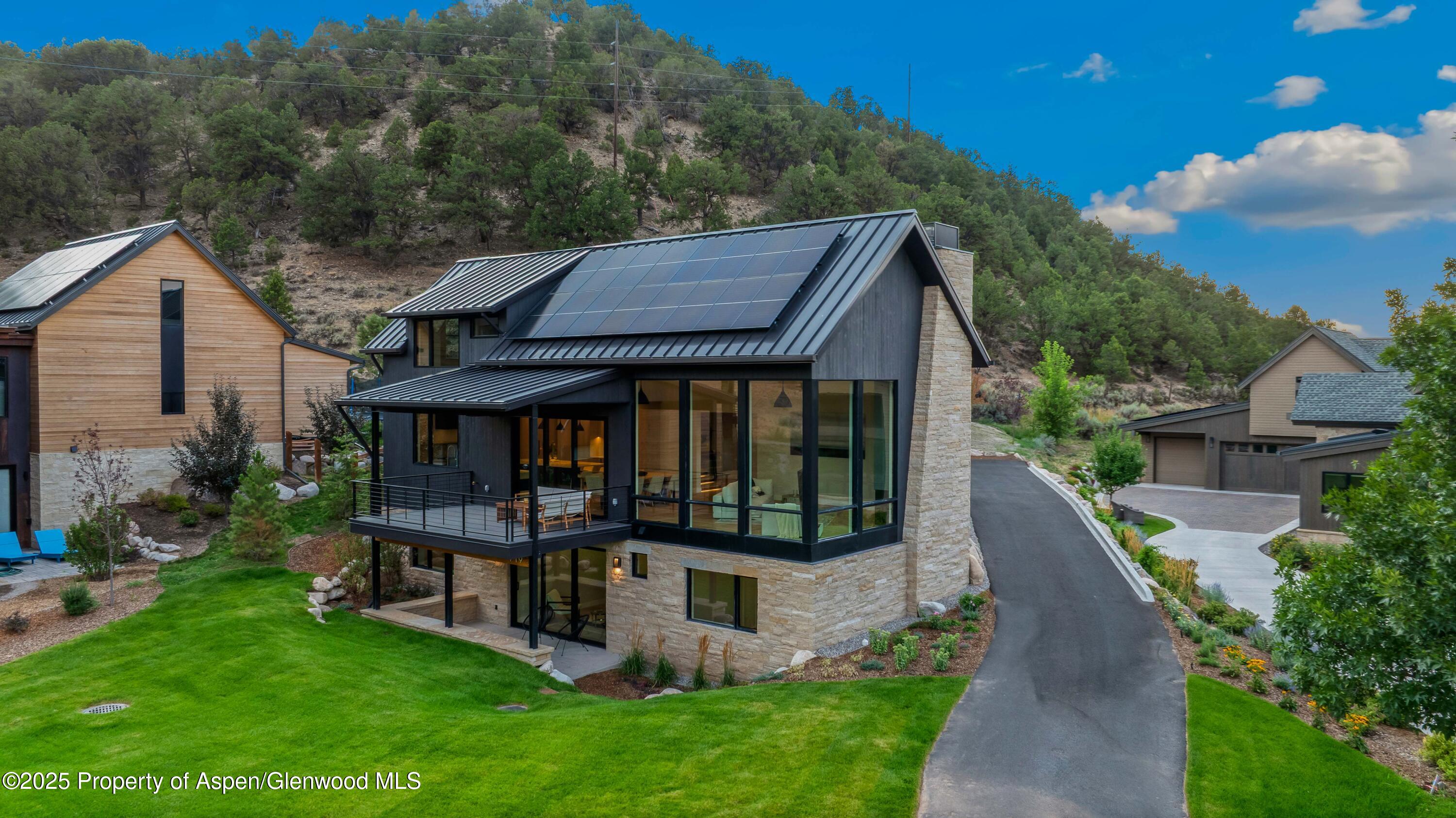 719 Perry Ridge Carbondale, CO 81623 - Photo 46 of 68 a view of a house with backyard and a hammock