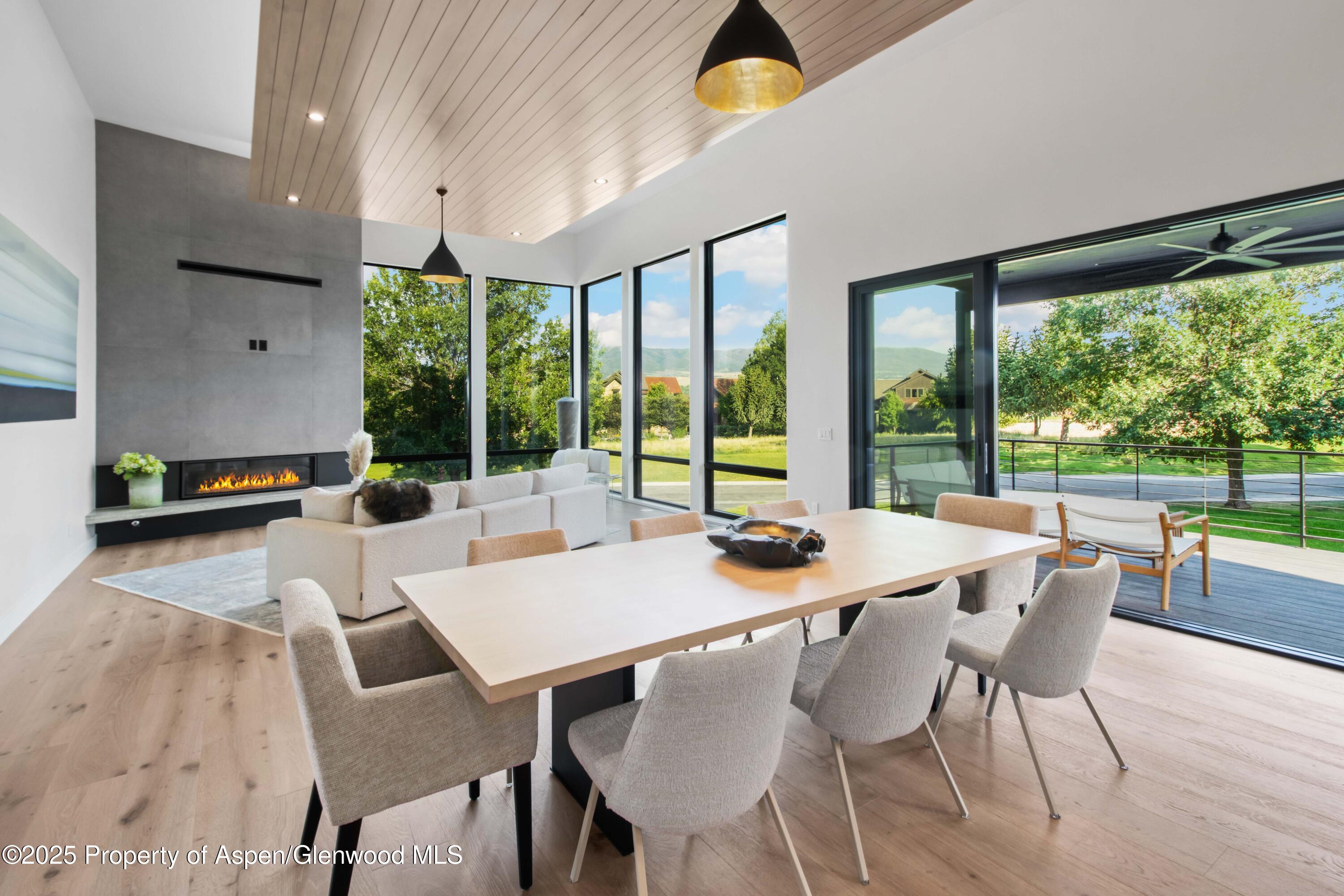 719 Perry Ridge Carbondale, CO 81623 - Photo 54 of 68 a view of a dining room with furniture large windows and wooden floor
