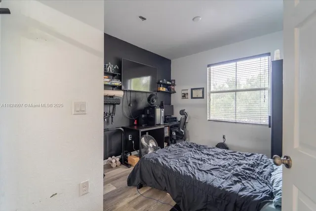 a bedroom that has a bed and a window in it