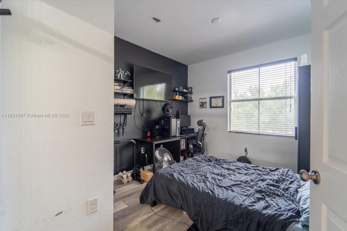 370 Lake Monterey Circle Boynton Beach, FL 33426 - Photo 11 of 17 a bedroom that has a bed and a window in it