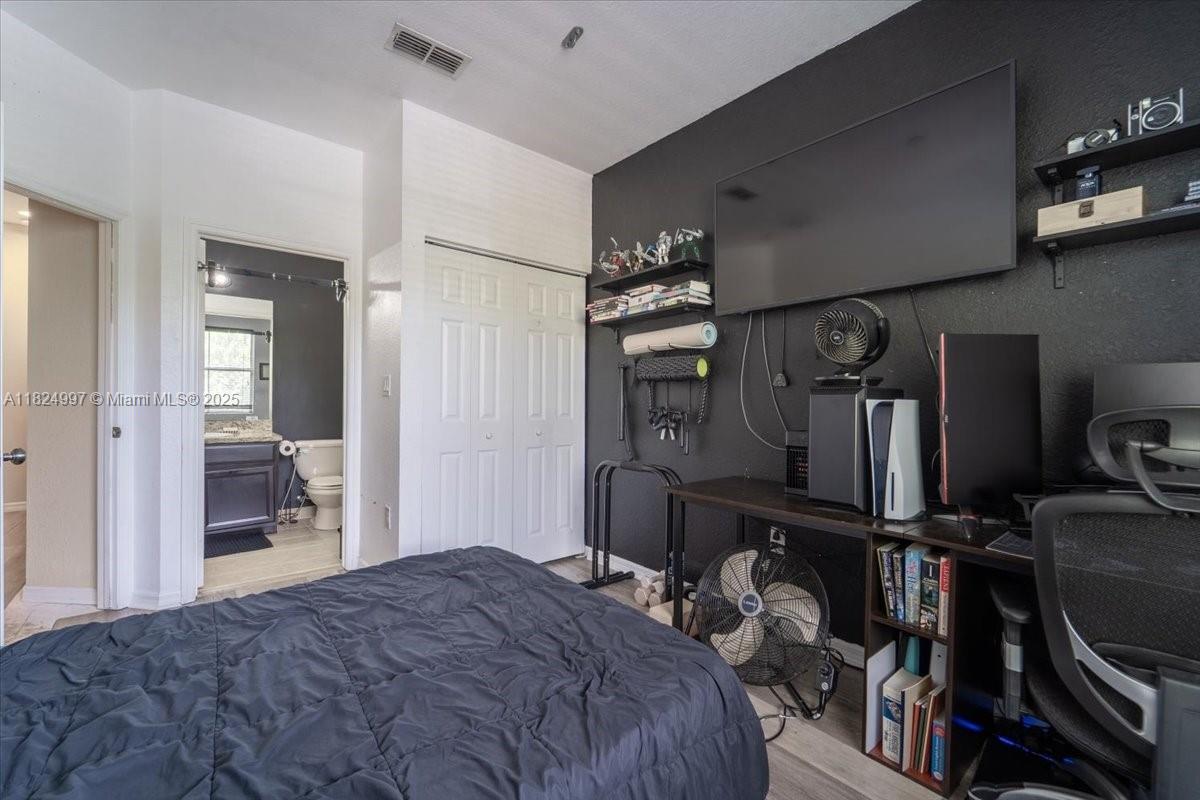 370 Lake Monterey Circle Boynton Beach, FL 33426 - Photo 13 of 17 a bedroom with a bed and a mirror